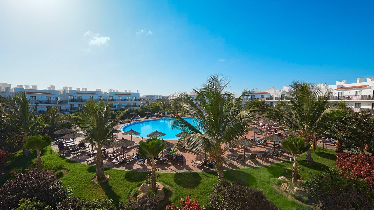Exotic holiday in Cape Verde — resort with pool and palm trees on the island of Sal.
