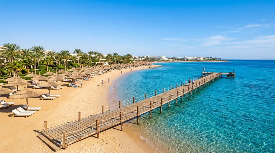 Hurghada charter holiday — beach with a long pier and straw umbrellas on the Red Sea